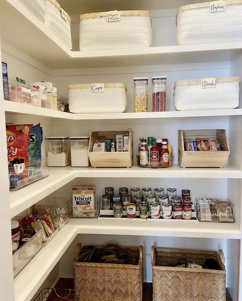 Labeled baskets and bins in a pantry organized by Porter New Orleans