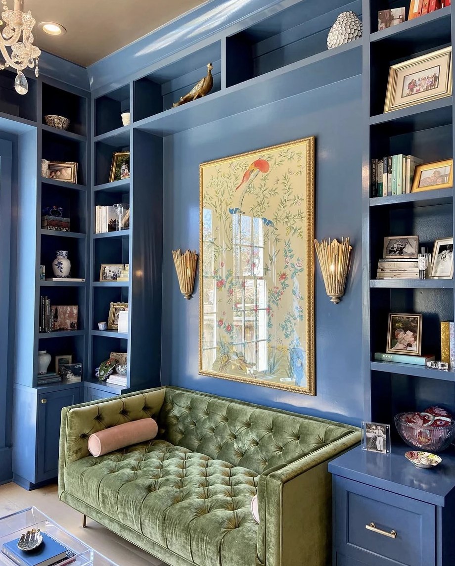 A navy built-in bookshelf styled by Porter New Orleans in Covington