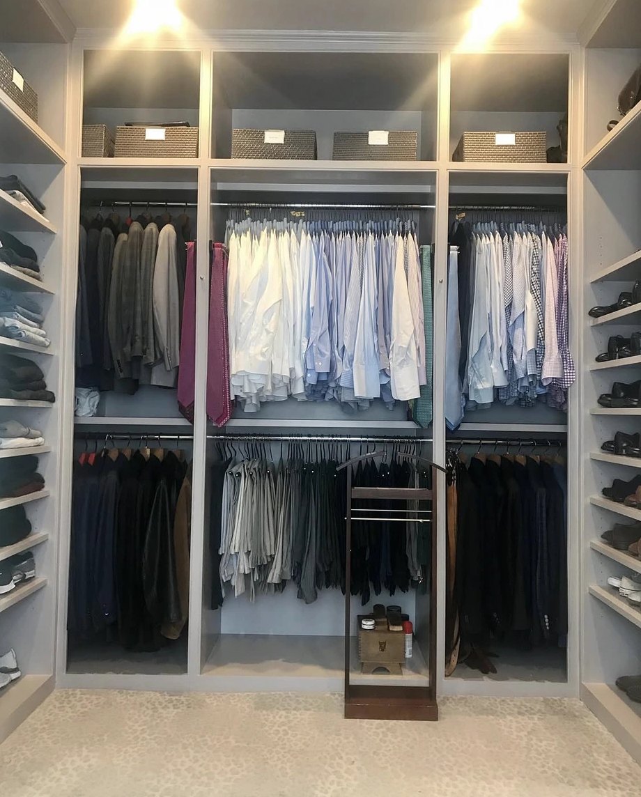 A men's master closet organized by Porter New Orleans in Uptown